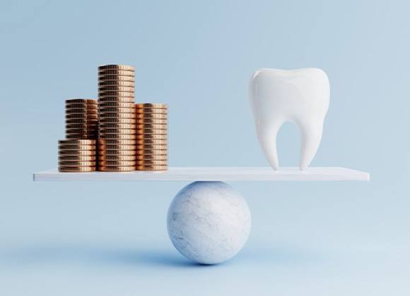 Tooth balanced against coins on scale