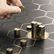 Hand counts coins on gameboard