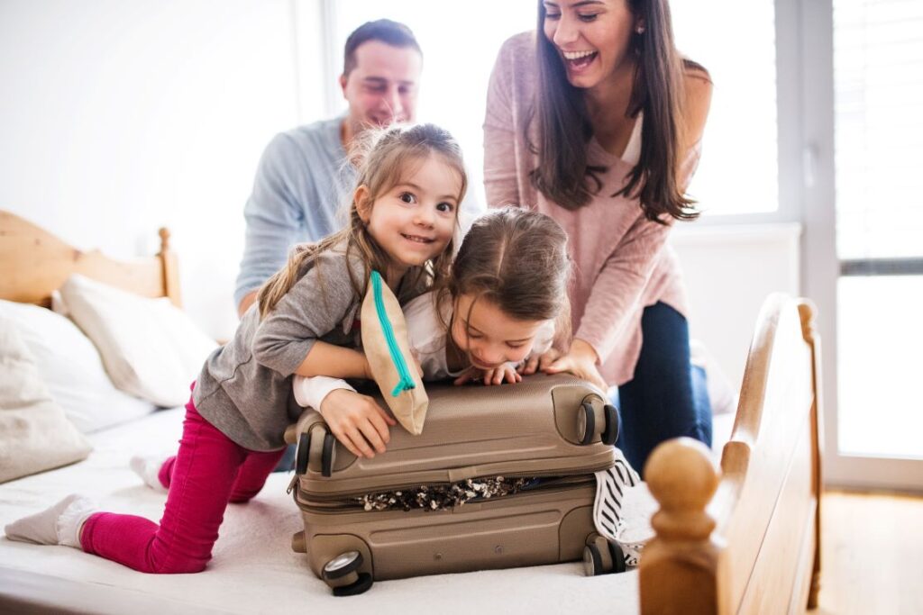 Family packing a suitcase together